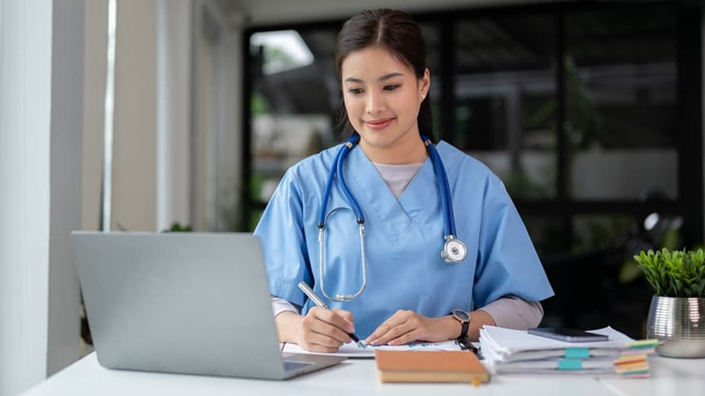 A nurse studies for class during a work break